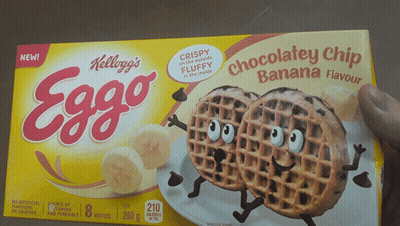 Someone Is Holding A Box Of Kellogg 'S Eggo Chocolate Chip Banana Flavour Waffles GIF