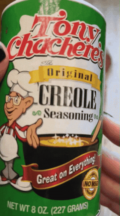 Someone Is Holding A Can Of Tony Chacheries Original Creole Seasoning GIF