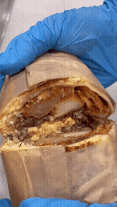 Someone Wearing Blue Gloves Is Holding A Burrito GIF
