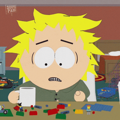 South Park Character Sitting At Table With Toys GIF