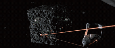 Nave espacial volando cerca de un cubo iluminado GIF