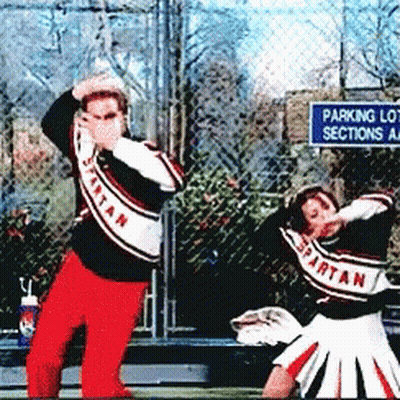 Spartan Cheerleaders Dancing In Front Of Parking Lot Sign GIF