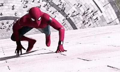 Spider-Man Is Crawling On The Ground In Front Of A Crowd . GIF