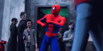 Spider-Man Is Flexing His Muscles In Front Of A Group Of People In A Crowd . GIF