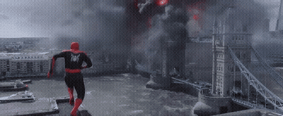 Spider-Man Is Flying Through The Air With His Arms Outstretched In A Cloudy Sky . GIF