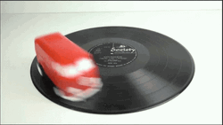 Spinning Bus Toy On Broken Record GIF