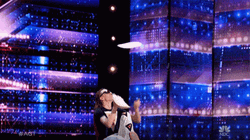 Spinning Juggling Pizza On Stage GIF