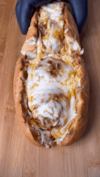 Splitting A Cheesy Meatball Sub Into Two GIF