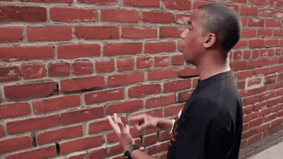 SpongeBob And Squidward Laying Beside Brick Wall Saying Just The Three Of Us GIF
