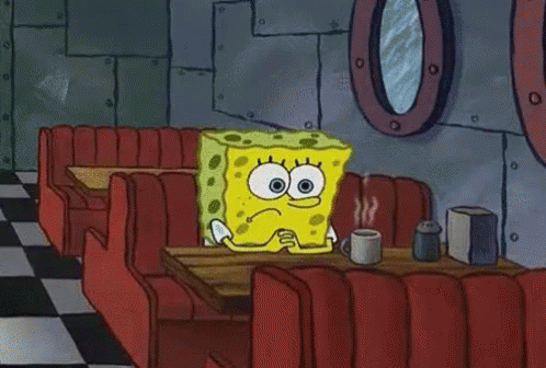 Spongebob Is Sitting At A Table In A Diner With A Cup Of Coffee . GIF