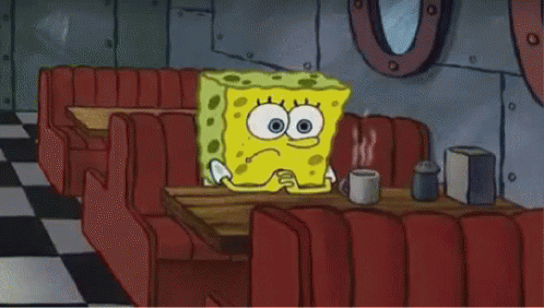 Spongebob Sits At A Table In A Diner GIF