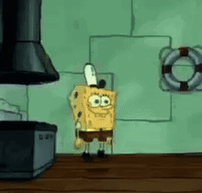 Spongebob Squarepants Is Standing On A Wooden Table In Front Of A Stove . GIF