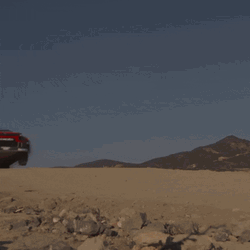Sports Car Flying Over Dirt GIF
