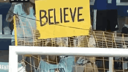 Sports Fan Raising Ted Lasso Believe Sign GIF