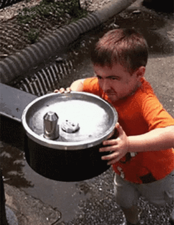 Spout Of Water On Kid's Head GIF