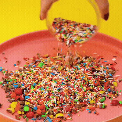 Sprinkles Poured Into Pink Plate GIF