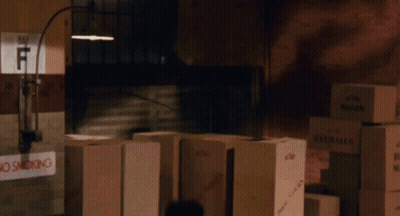 Stack of Boxes in Dark Room With No Smoking Sign