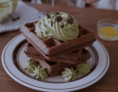 Stack Of Chocolate Waffles With Green Frosting And Chocolate Chips GIF