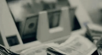 Stack Of Money Next To Machine GIF