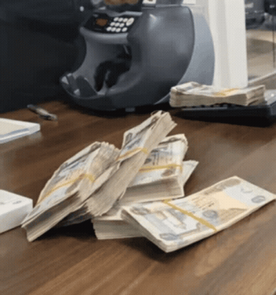 Stack Of Money Next To Machine Saying 0000 GIF
