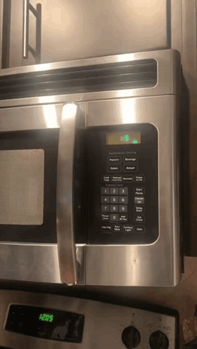 Stainless Steel Microwave Oven Set To 3:28 GIF