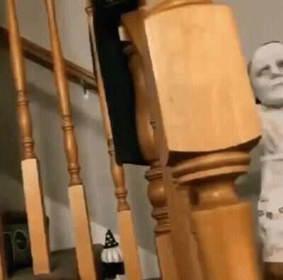 Staircase With Wooden Railing And Mummy Statue GIF