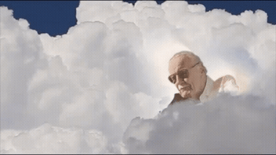 Stan Lee Laying In Clouds With Light Coming Out Of Head GIF
