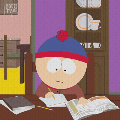 Stan Marsh From South Park Sits At A Desk With A Book GIF