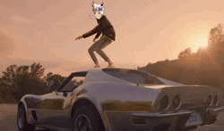 Standing Above The Running Race Car GIF