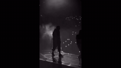 Standing Silhouette On Stage In Dark GIF