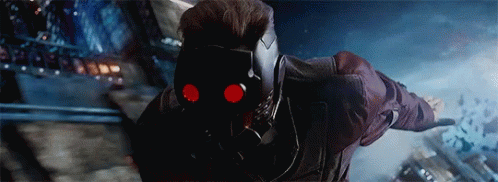 Star Lord From Guardians Of The Galaxy Is Wearing A Helmet With Red Eyes And Is Flying Through The Air . GIF