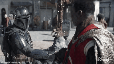 Star Wars Man In Red Vest Shaking Hands With Helmeted Man GIF