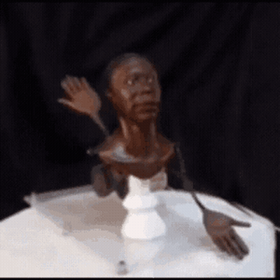 Statue Of A Man's Head On A Table GIF