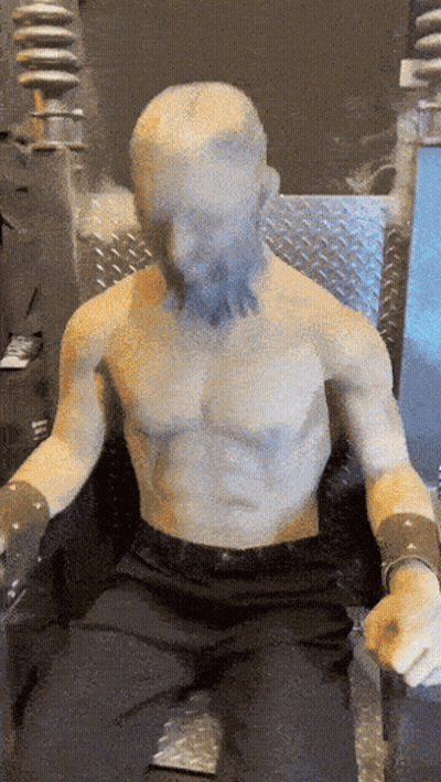 Statue Of Bearded Man Sitting In Chair GIF
