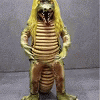 Statue Of Dinosaur With Long Blonde Hair GIF