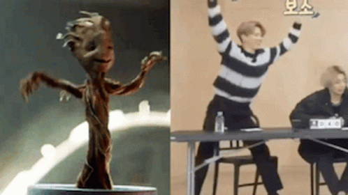 Statue Of Groot Standing Next To Picture Of Man At Table GIF