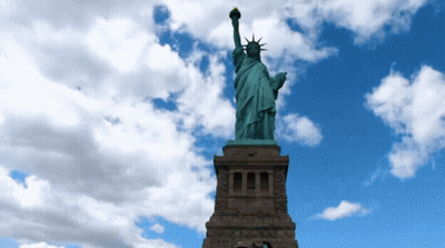 Statue Of Liberty In Front Of Blue Sky GIF