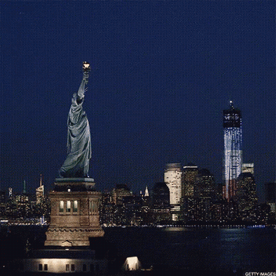 Statue Of Liberty In Front Of Twin Towers GIF