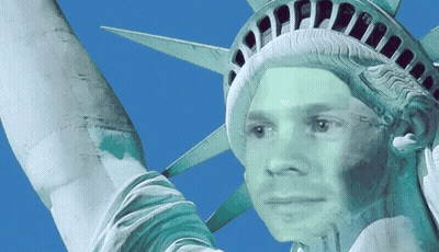 Statue Of Liberty With Man's Face Painted On It GIF