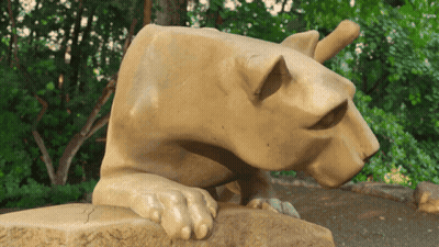 Statue Of Lioness Laying On Rock GIF