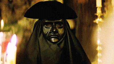 Statue Of Man In Black Mask And Hat GIF