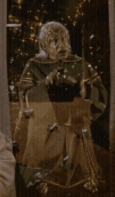 Statue Of Man In Front Of Mirror With Lights GIF