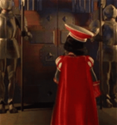 Statue Of Man In Red Cape At Door GIF
