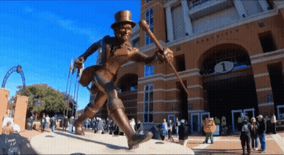 Statue Of Man In Top Hat And Cane In Front Of Army Field Building GIF