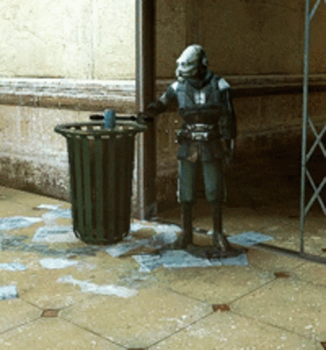 Statue Of Man Standing Next To Trash Can GIF