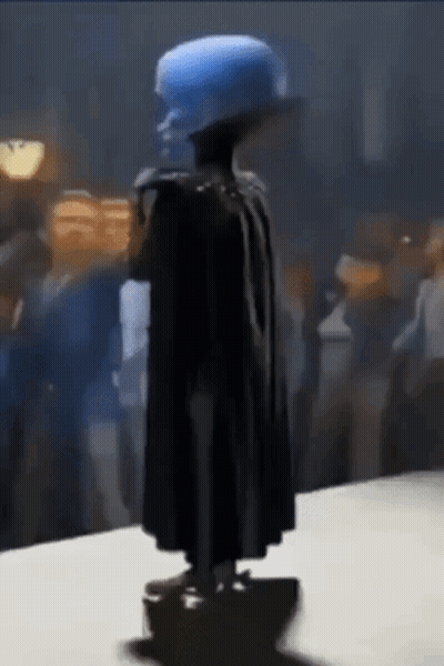 Statue Of Man With Blue Hat And Cape GIF