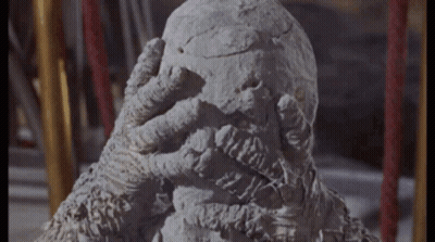 Statue Of Monster Covering Face With Hand GIF