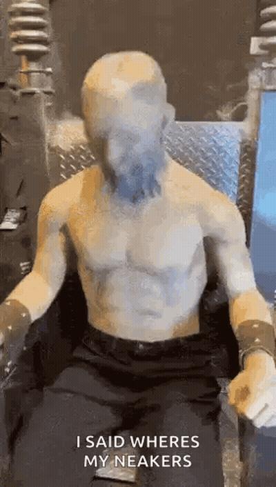 Statue Of Shirtless Man Sitting With Face Covered GIF