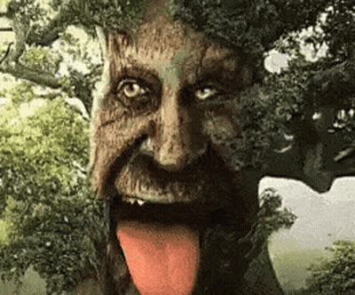 Statue Of Tree With Beard And Tongue Sticking Out GIF