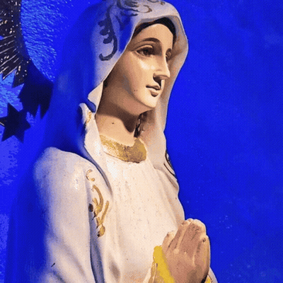 Statue Of Woman In White Robe And Blue Cape GIF
